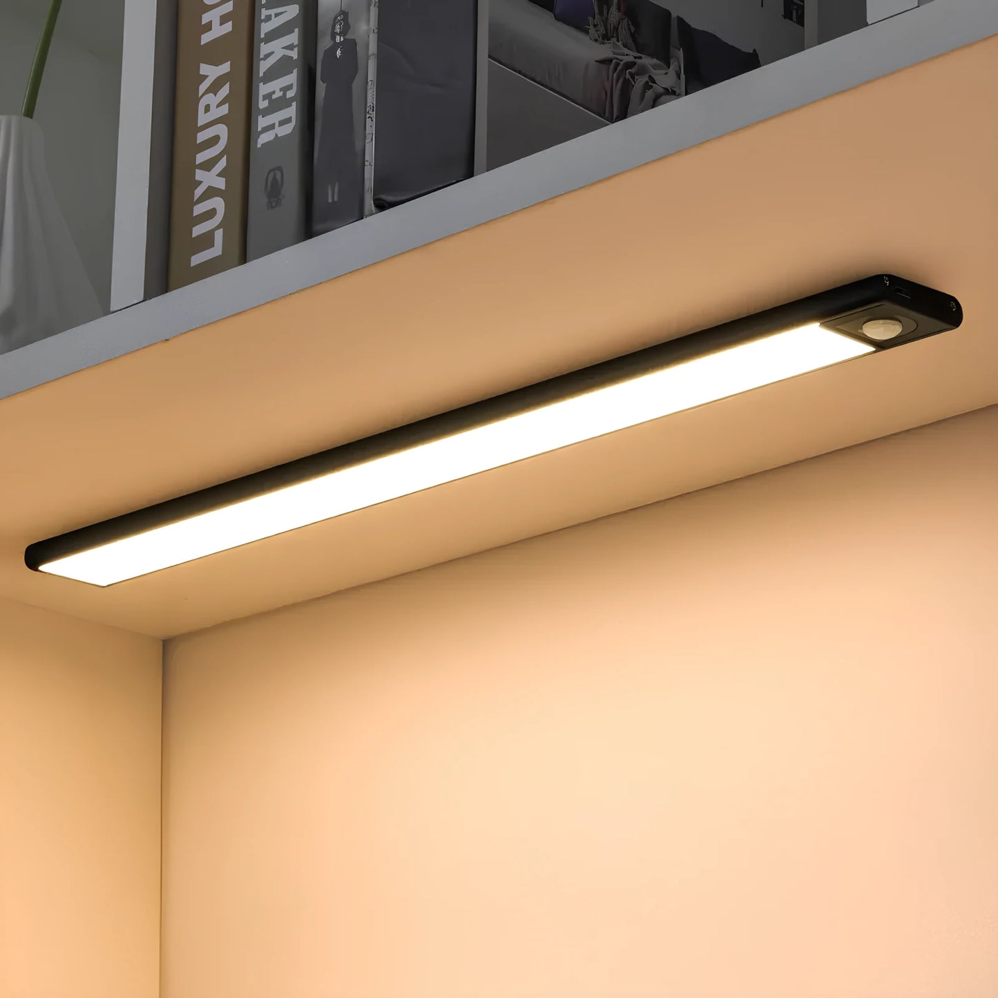 Josh & Tate - GlowMotion Motion Sensor Lamp - Under-cabinet LED light strip on a kitchen shelf with books in the background