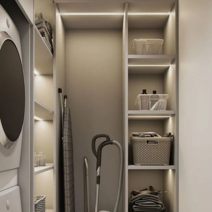 Josh & Tate - GlowMotion Motion Sensor Lamp - Modern laundry room with shelves, washing machine, and cleaning supplies.