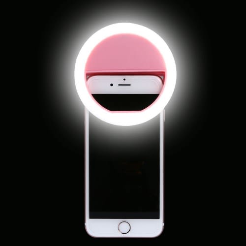 Smartphone with a pink ring light attachment on a black background