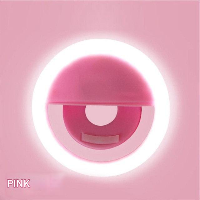 Pink circular object with a white light on a pink background