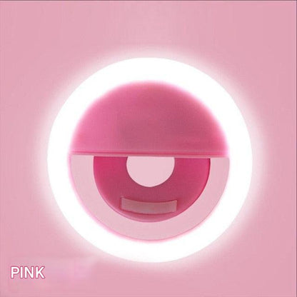 Pink circular object with a white light on a pink background