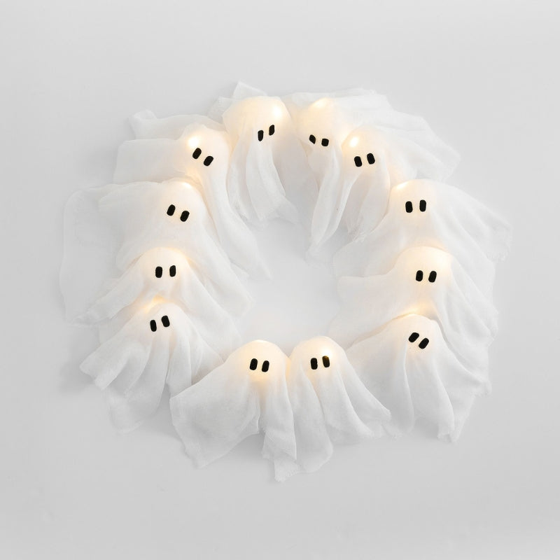 Decorative wreath with ghost-shaped lights on a white background