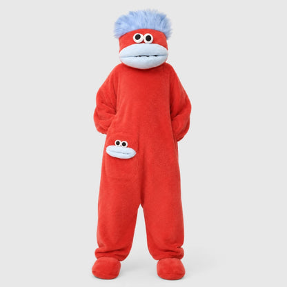 Josh & Tate - GoofSuit™ Big Mouth Monster Onesie - A child wearing a red plush monkey costume jumpsuit with a blue furry headpiece, white face panel, and small monkey face patch on the leg, photographed against a light gray studio background.