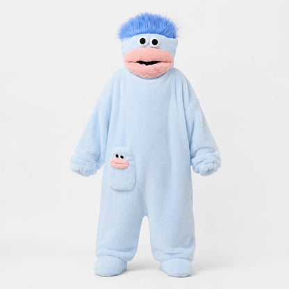 Josh & Tate - GoofSuit™ Big Mouth Monster Onesie - A plush character footie one-piece pajama in light blue with a pink mouth, black eyes, and bright blue hair, shown on a plain light gray background.