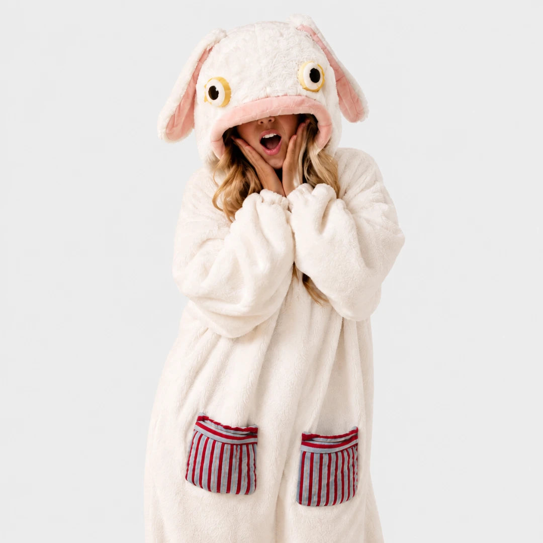 Josh & Tate - GoofSuit™ Big Mouth Monster Onesie - A person wearing a plush animal-style hooded robe in off-white with pink inner ears and red-and-white striped pocket details, posed against a light gray studio background.