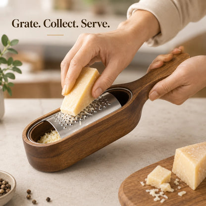 Josh & Tate - GrateTrough™ Wooden Cheese Grater - A wooden handheld cheese grater with a stainless steel grating surface, shown being used with a wedge of Parmesan cheese. A person's hands are visible holding the product and cheese, set on a light countertop with a blurred kitchen background and text overlay 'Grate.