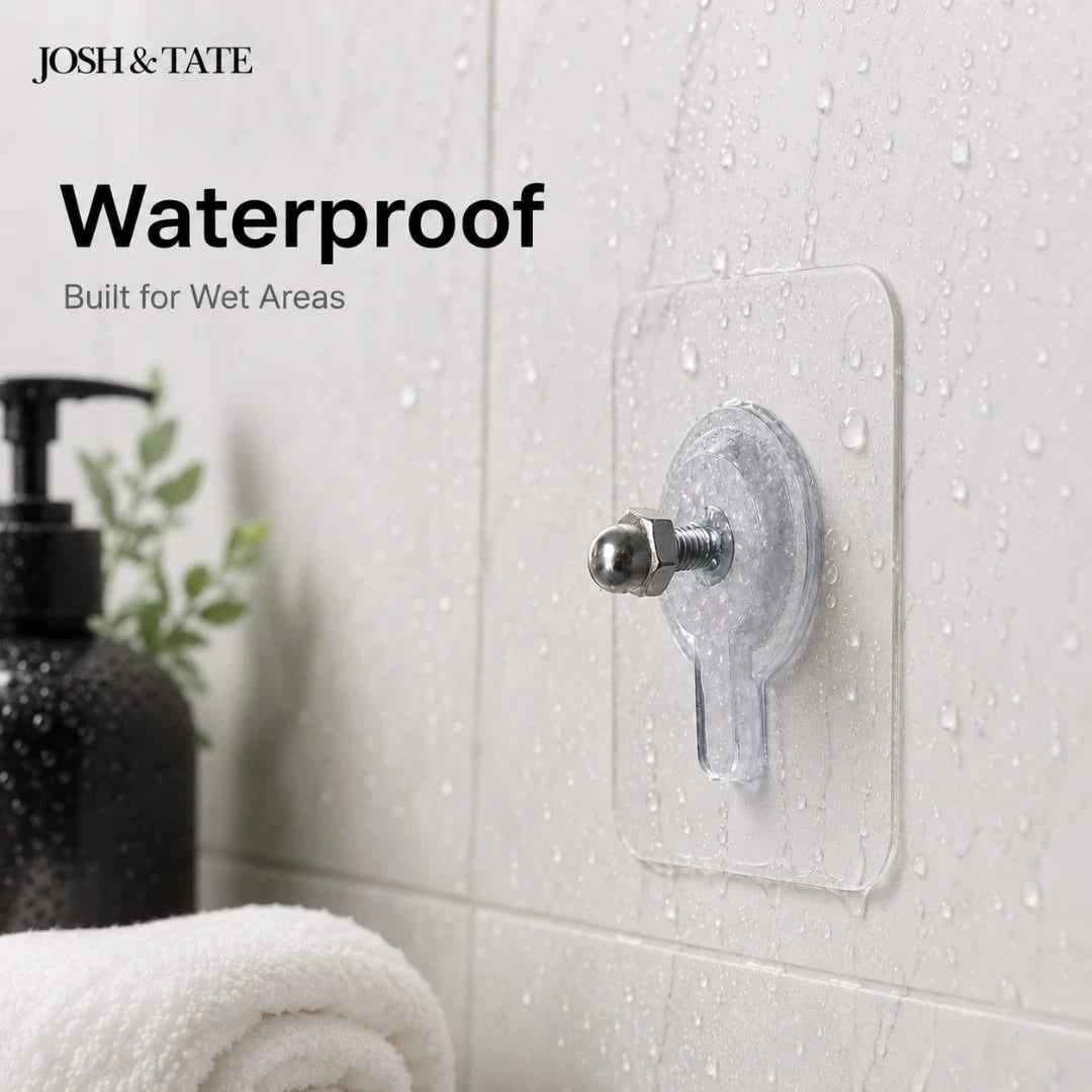 Josh & Tate - GripDot™ Adhesive Wall Hook - Transparent adhesive hook on a bathroom wall with 'Josh & Tate' branding and text about waterproof features.