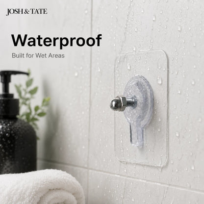 Josh & Tate - GripDot™ Adhesive Wall Hook - Transparent adhesive hook on a bathroom wall with 'Josh & Tate' branding and text about waterproof features.