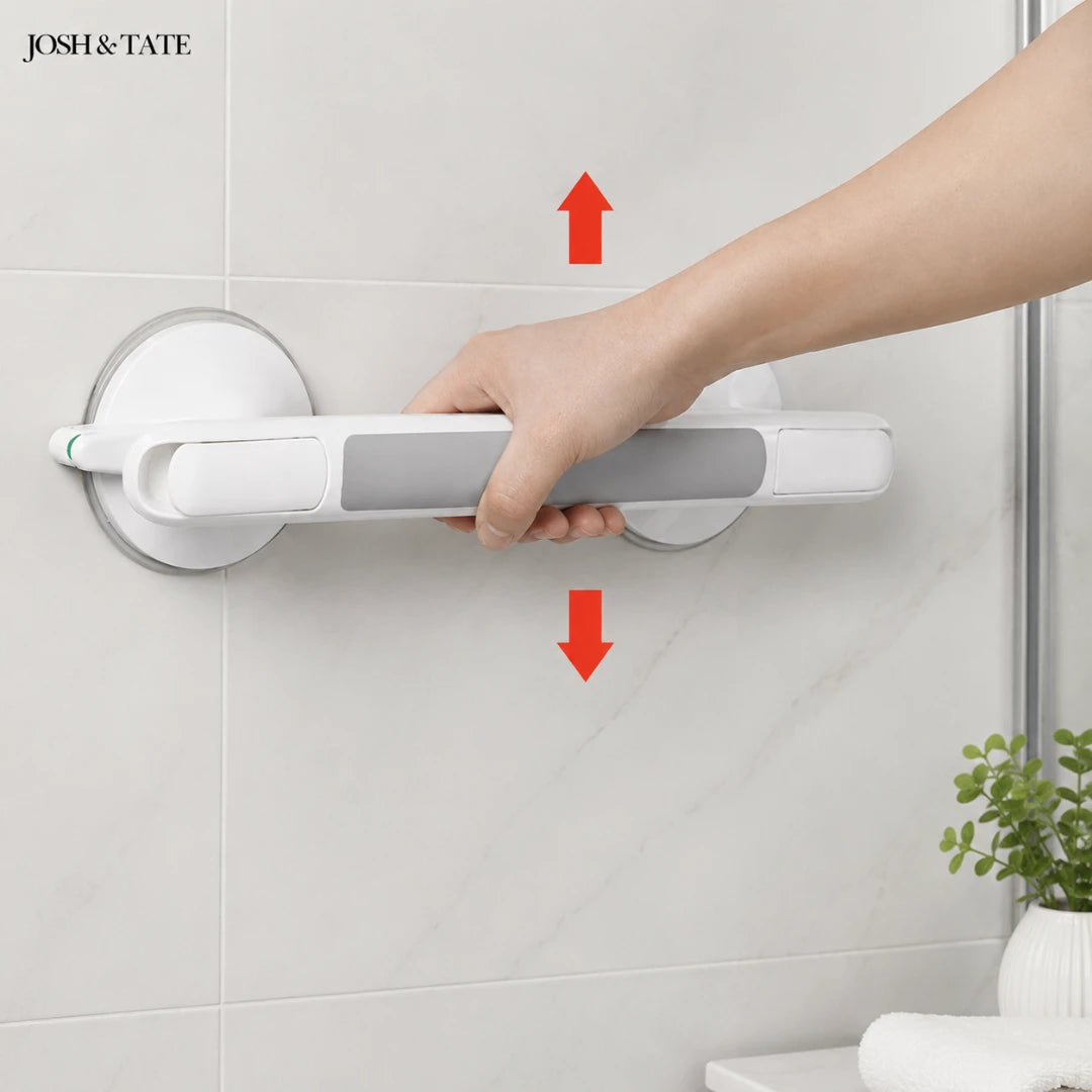 Josh & Tate - GripSafe™ Suction Shower Grab Bar - Hand holding a white and gray grab bar against a tiled wall with 'JOSH & TATE' branding.