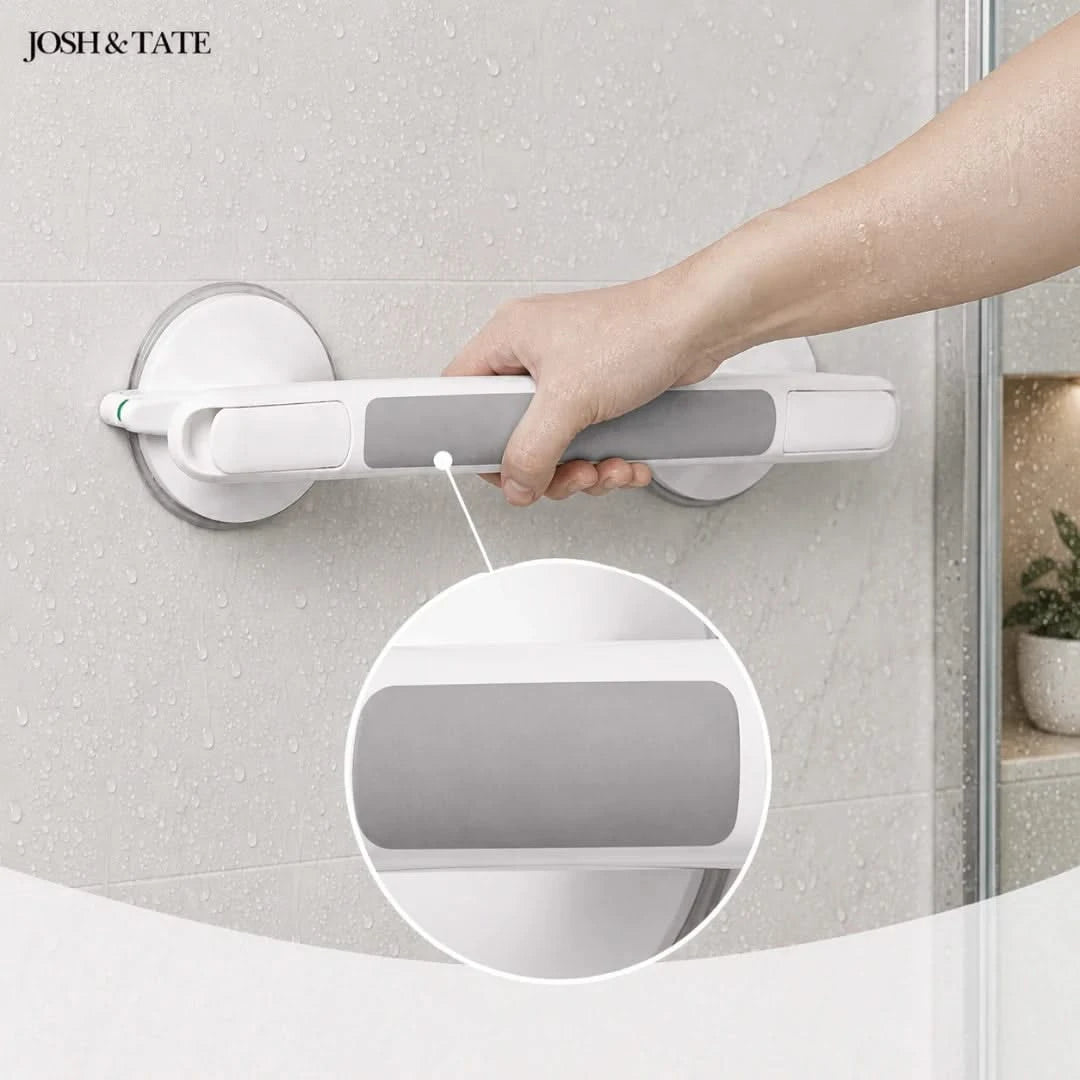 Josh & Tate - GripSafe™ Suction Shower Grab Bar - Hand holding a white grab bar against a textured wall, with 'JOSH & TATE' branding.