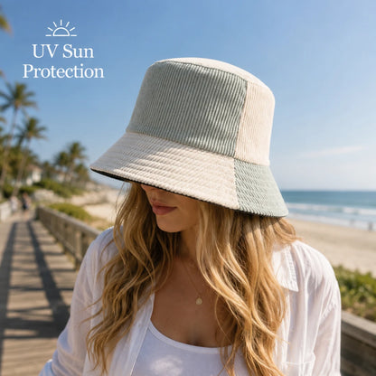 Josh & Tate - HalfTone™ Corduroy Bucket Hat - A woman wearing a wide-brimmed corduroy bucket hat in a beach setting, with palm trees and ocean in the background. The text 'UV Sun Protection' with a sun icon is visible in the top left corner.