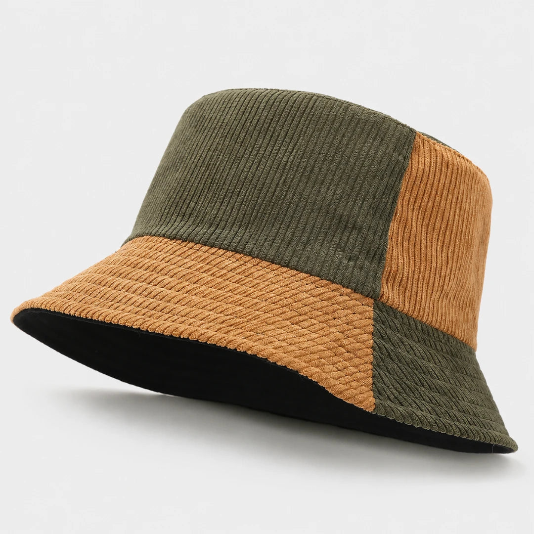 Josh & Tate - HalfTone™ Corduroy Bucket Hat - A patchwork corduroy bucket hat featuring olive green and mustard yellow panels, with a black underside on the brim, shown on a light gray background.