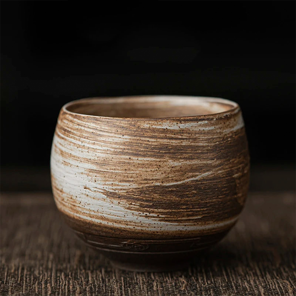 Stoneware cup with a textured surface on a dark background