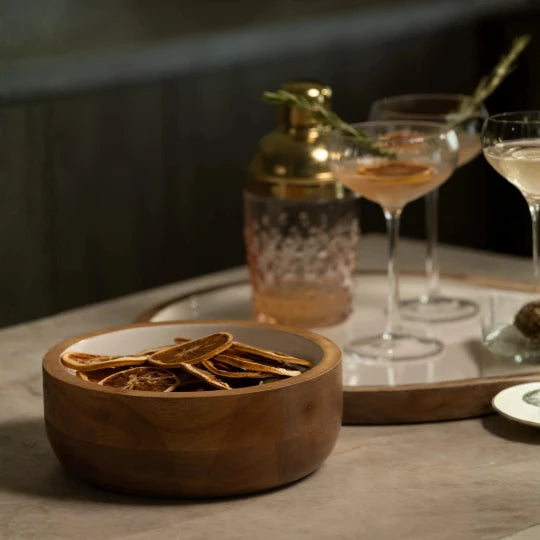 Josh & Tate - Hayes Wooden White Nesting Bowls - Set of 2 - Wooden bowl with dried herbs on a table with cocktails in the background