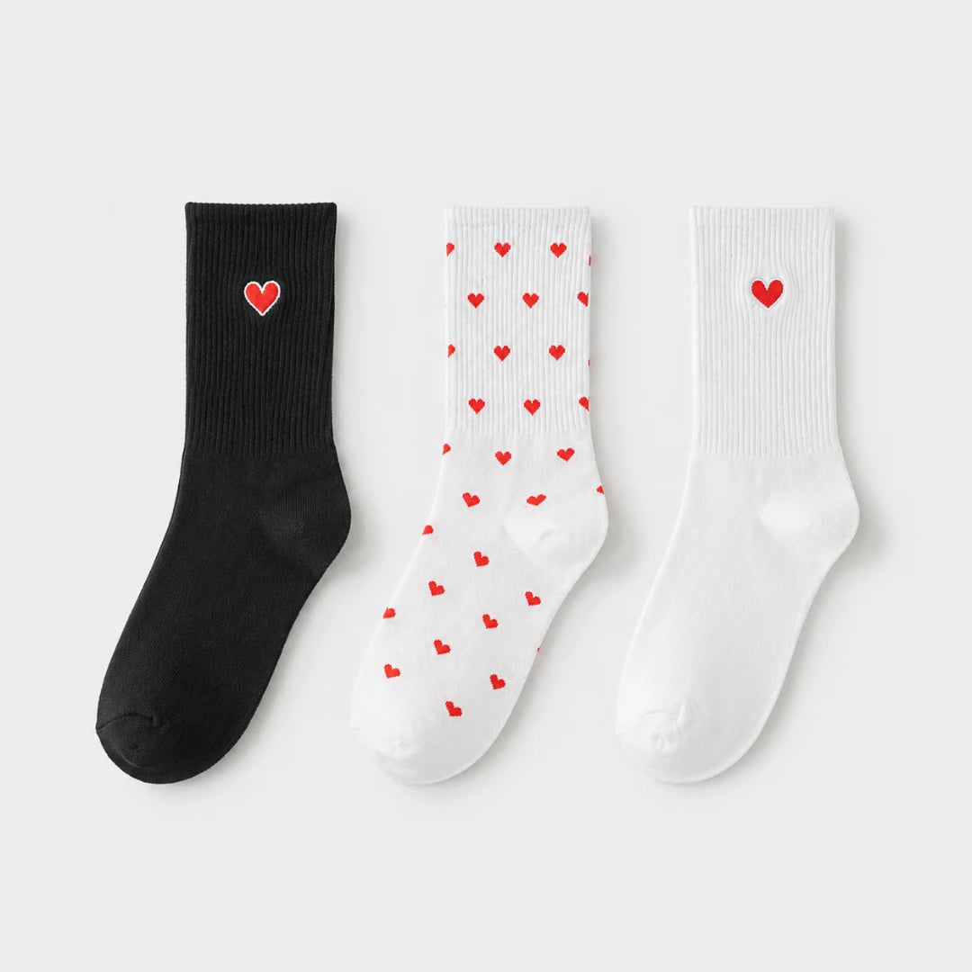 Josh & Tate - HeartStep™ Heart Crew Socks - Three socks with heart patterns on a light gray background