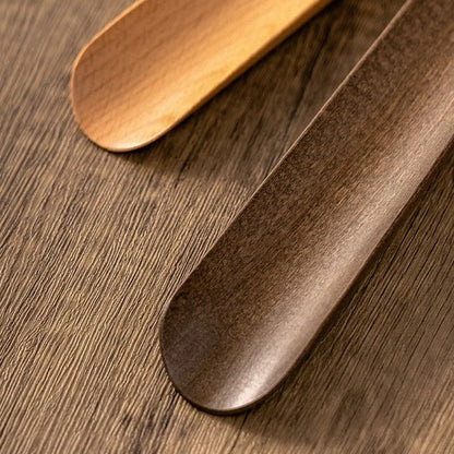 Two wooden spoons on a wooden surface
