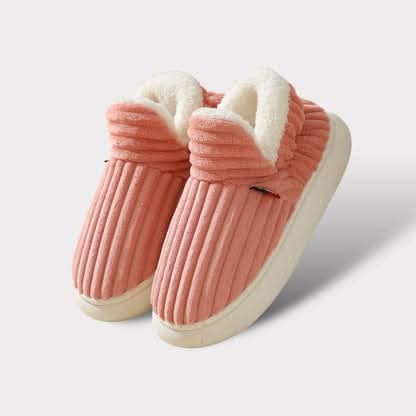 Pair of pink slippers with white interior on a light gray background