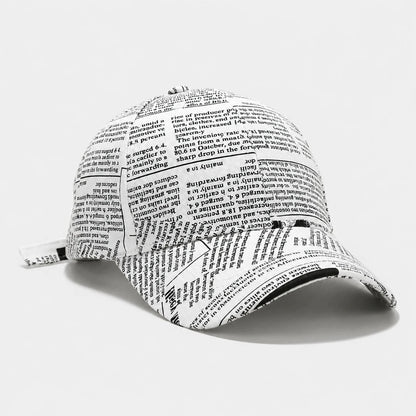 Josh & Tate - InkPress™ Newsprint Cap - A baseball cap printed with dense black text resembling a dictionary or encyclopedia page, shown on a clean white background.
