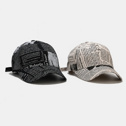 Josh & Tate - InkPress™ Newsprint Cap - Two baseball caps, one black and one gray with newspaper print, on a light gray background.