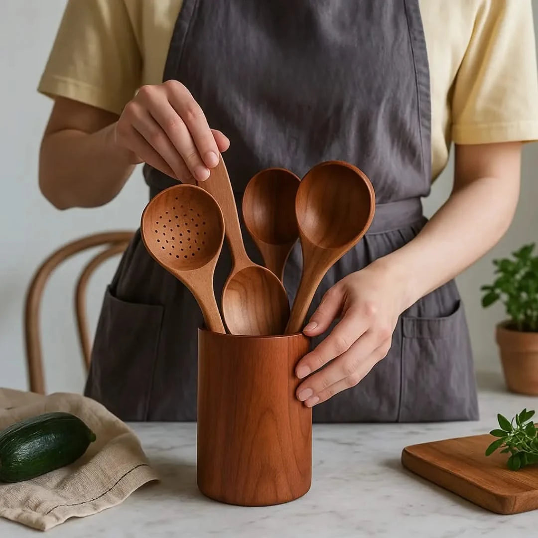 Josh&Tate Acacia Utensil Holder - Person holding a wooden container with wooden spoons on a kitchen counter.