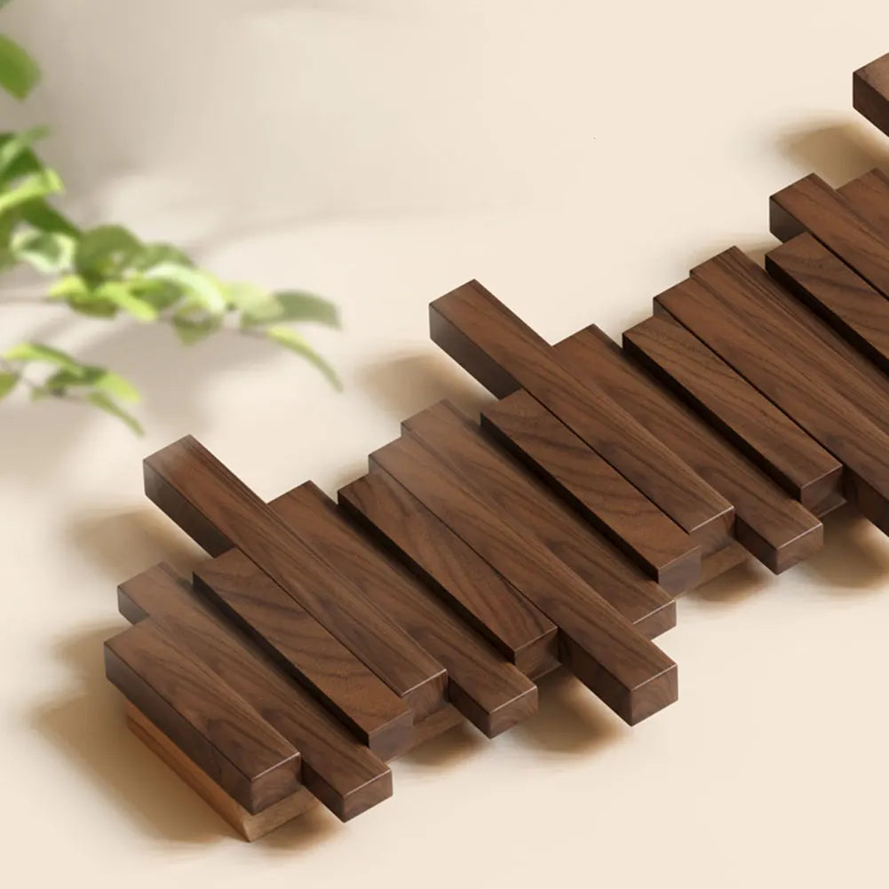 Wooden coaster set on a light surface with a plant in the background