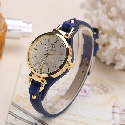 Wristwatch with blue strap and gold accents on a decorative background