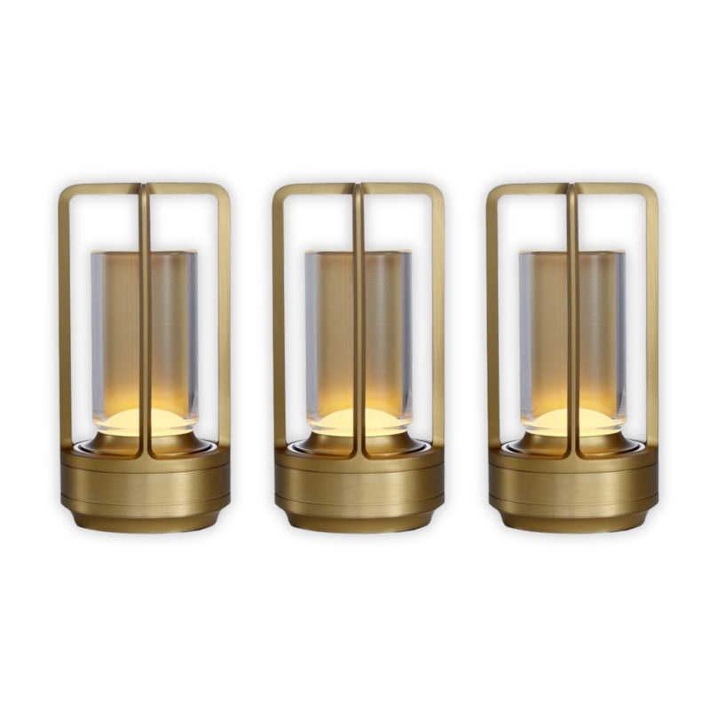 Three gold lanterns with glass shades on a white background