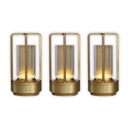 Three gold lanterns with glass shades on a white background