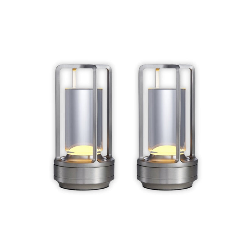 Two cylindrical metal lamps with glass covers on a white background