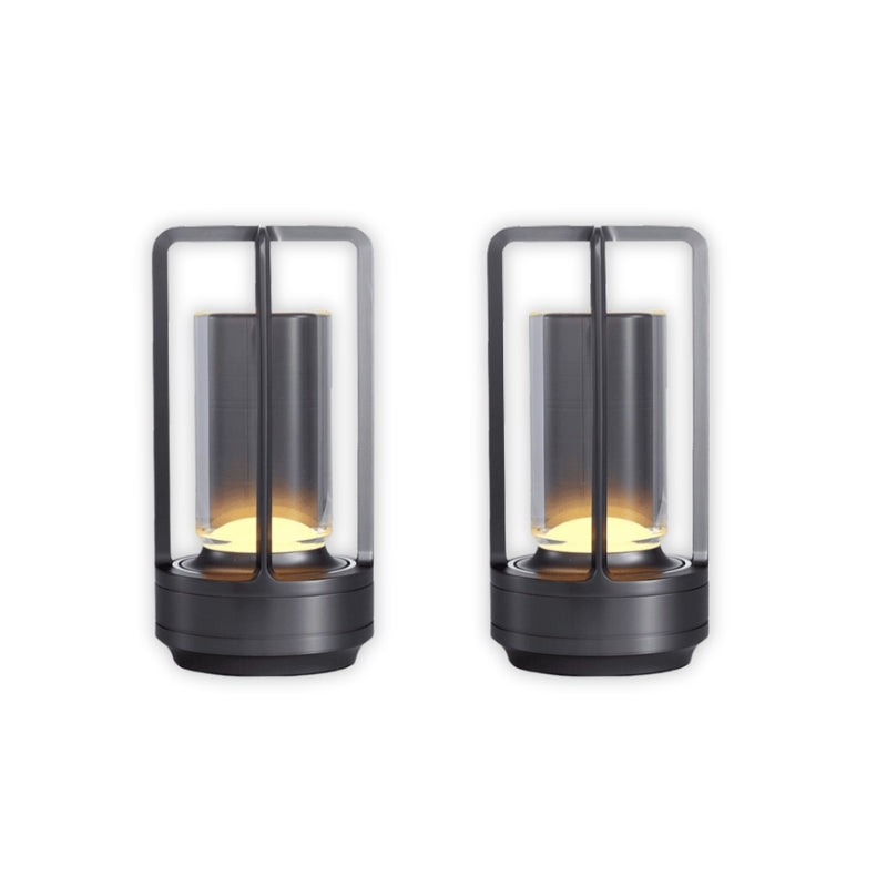 Two black lantern-style lamps with glass covers on a white background