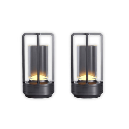 Two black lantern-style lamps with glass covers on a white background