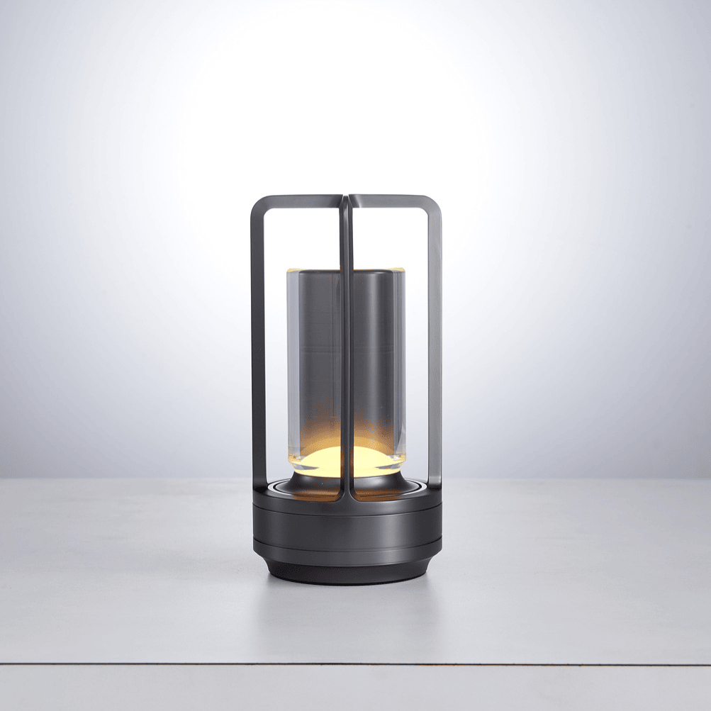 Modern lantern-style lamp with glass shade on a light gray background