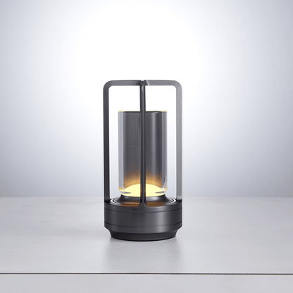 Modern lantern-style lamp with glass shade on a light gray background