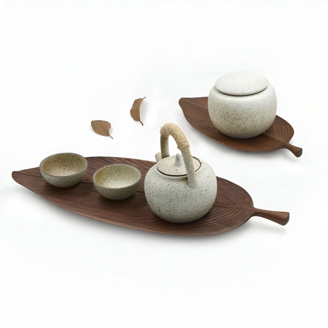 Josh & Tate - Leaf Shaped Wooden Serving Tray - Ceramic tea set with teapot, cups, and leaf-shaped trays on a white background