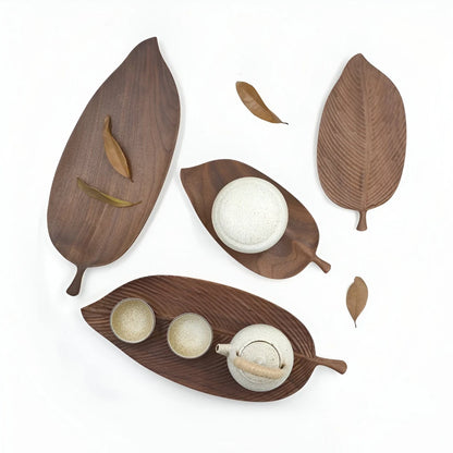 Josh & Tate - Leaf Shaped Wooden Serving Tray - Wooden leaf-shaped trays with ceramic items on a white background