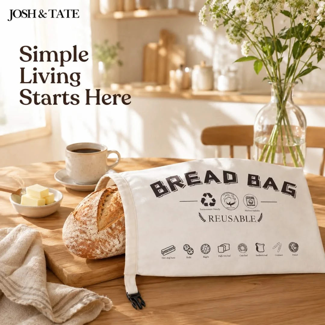 Josh & Tate - LoafSack™ Cotton Bread Bag - Bread bag on a table with bread, coffee, and flowers in a kitchen setting.