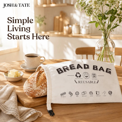 Josh & Tate - LoafSack™ Cotton Bread Bag - Bread bag on a table with bread, coffee, and flowers in a kitchen setting.