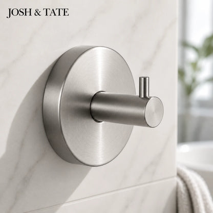 Josh & Tate -LockDisc™ Twist-Lock Wall Hook Set - Metallic wall hook on a tiled wall with 'JOSH & TATE' branding.