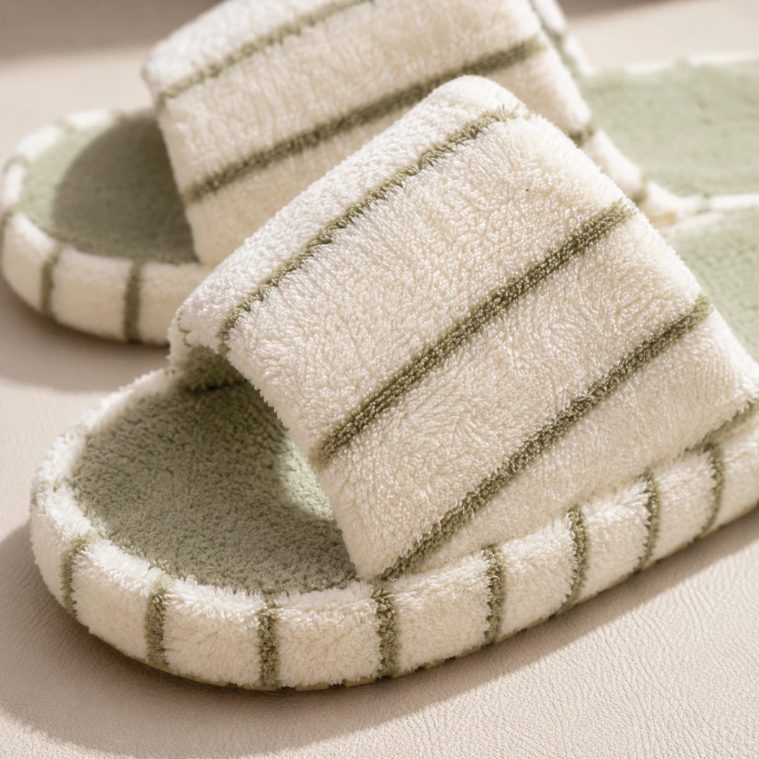 Josh & Tate - LoftWear™ Striped Slide Slippers - A pair of plush slide slippers with a cream-colored terry cloth upper and a sage green footbed, featuring thin sage green stripes along the edges.