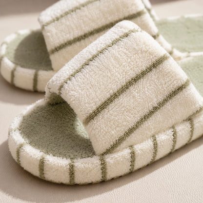 Josh & Tate - LoftWear™ Striped Slide Slippers - A pair of plush slide slippers with a cream-colored terry cloth upper and a sage green footbed, featuring thin sage green stripes along the edges.