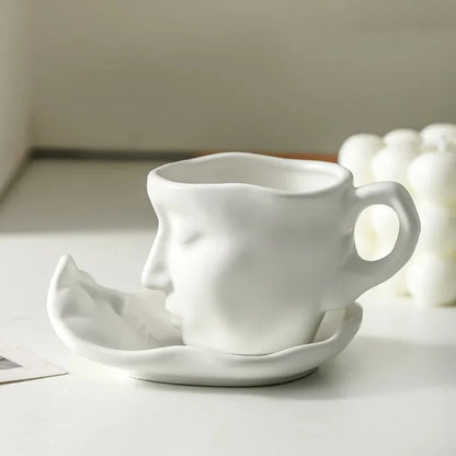 Josh & Tate - Lover's Gaze Reverie Coffee Ceramic Mug - White ceramic face-shaped mug and saucer on a light surface