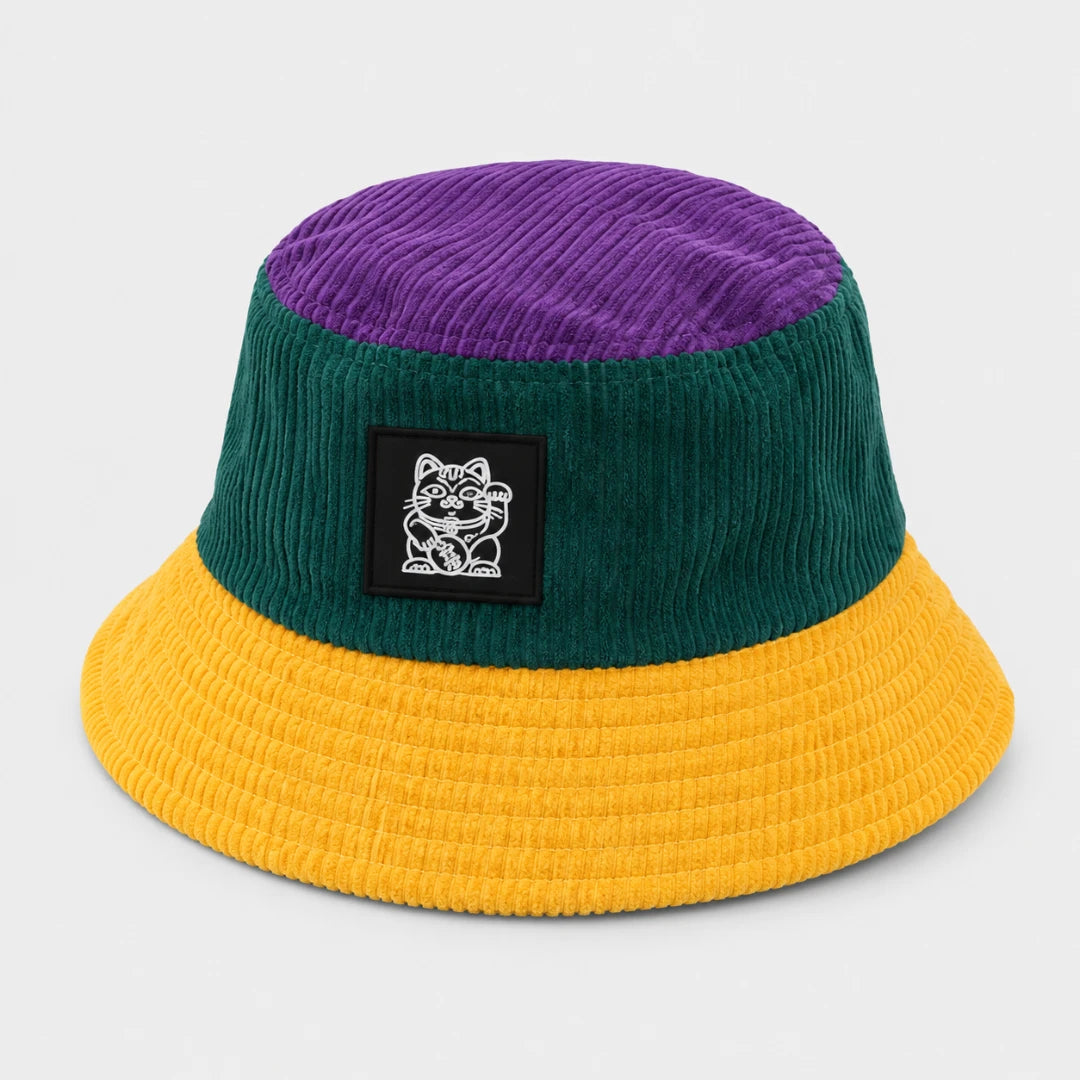 Josh & Tate - LuckyBrim™ Colorblock Bucket Hat - A three-color corduroy bucket hat with a purple crown, dark green band, and yellow brim, featuring a black rectangular patch with a white cat logo on the front.