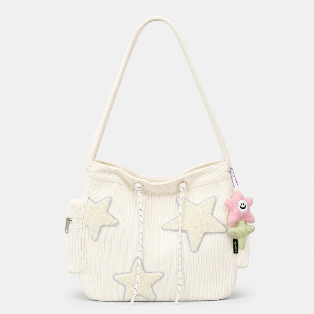 Josh & Tate - LuckyStar™ Ribbed Tote Bag  - An off-white corduroy shoulder bag with three large star appliques, white rope drawstrings, and a pink plush flower keychain charm.