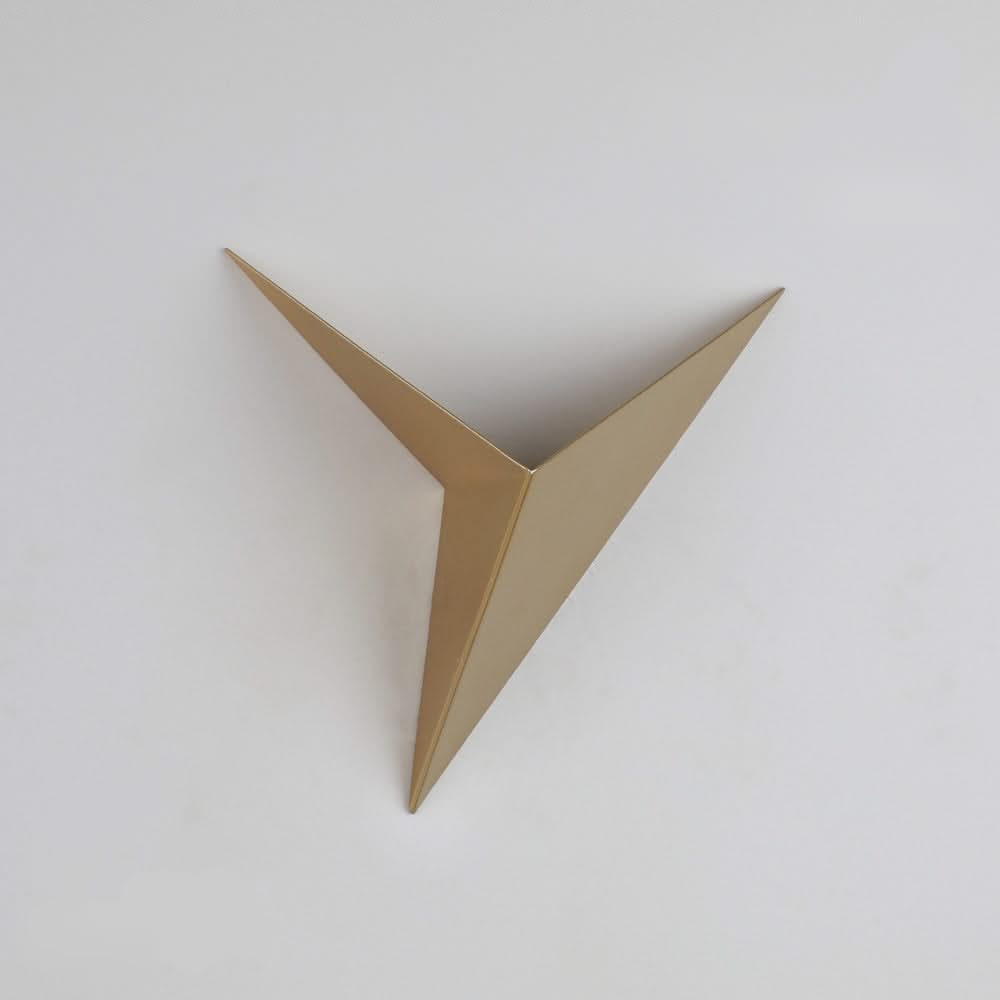 Gold metallic triangle wall art on a white background