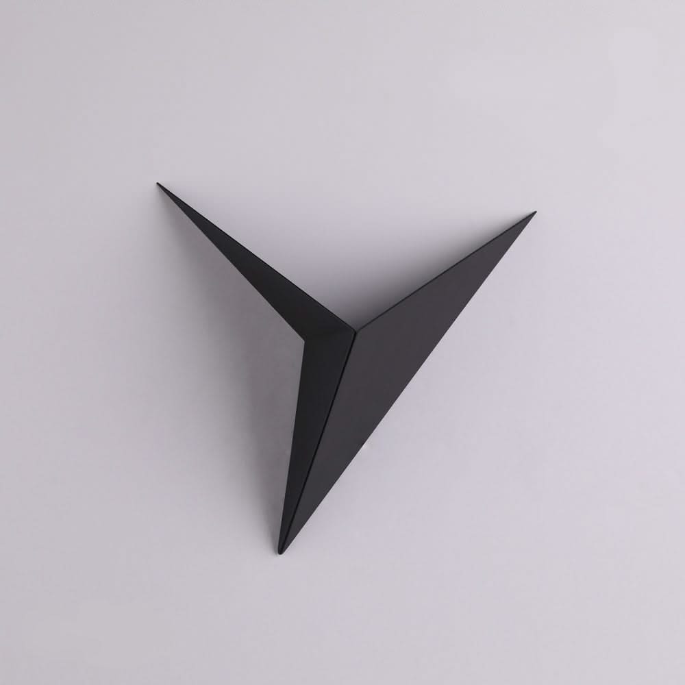 Black geometric wall art on a light gray background