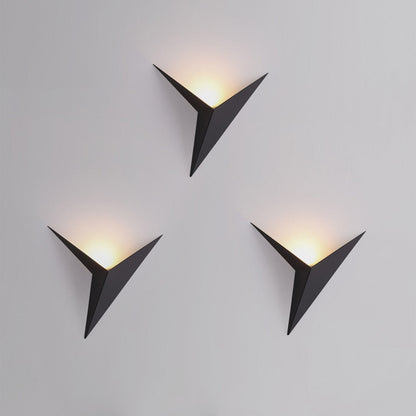 Three modern wall lights with triangular design on a gray background