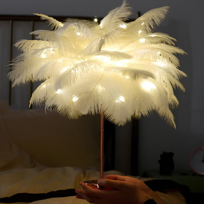 Feathered lamp with string lights held by a person in a bedroom setting