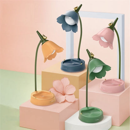 Flower-shaped lamps on colorful geometric blocks with a pastel background
