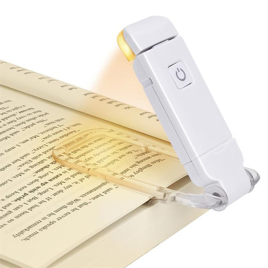 Reading lamp illuminating a book on a white background