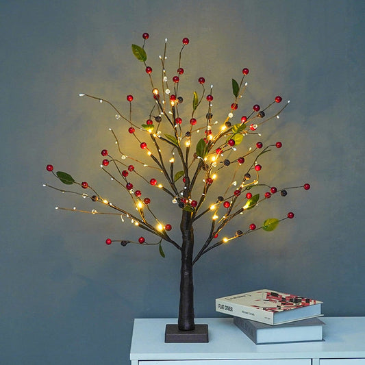 Decorative tree with lights and red berries on a plain background